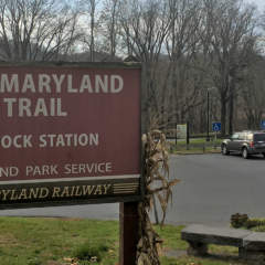 Parking lot with sign for Hancock Station at Western Maryland Rail Trail