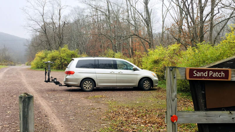 Parking lot with Sand Patch sign on fence